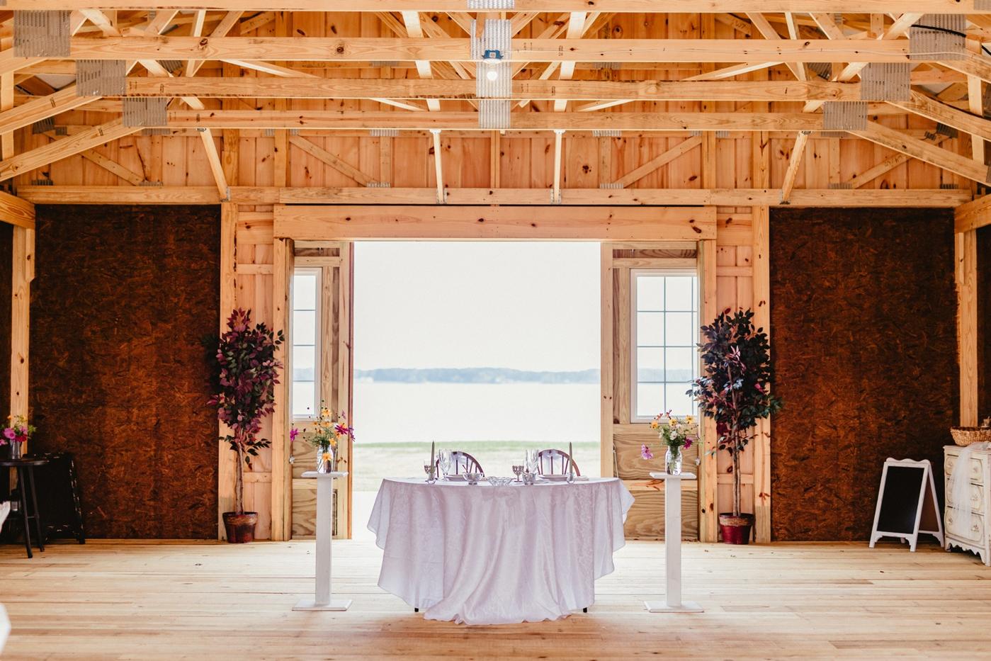 Interior view of the reception barn at Lower Notley Hall Farm, with riverside views and elegant decor.