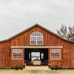 The exterior of the reception barn is a rusty, vibrant shade of red and has three large windows facing the farmlands and the Wicomico River.